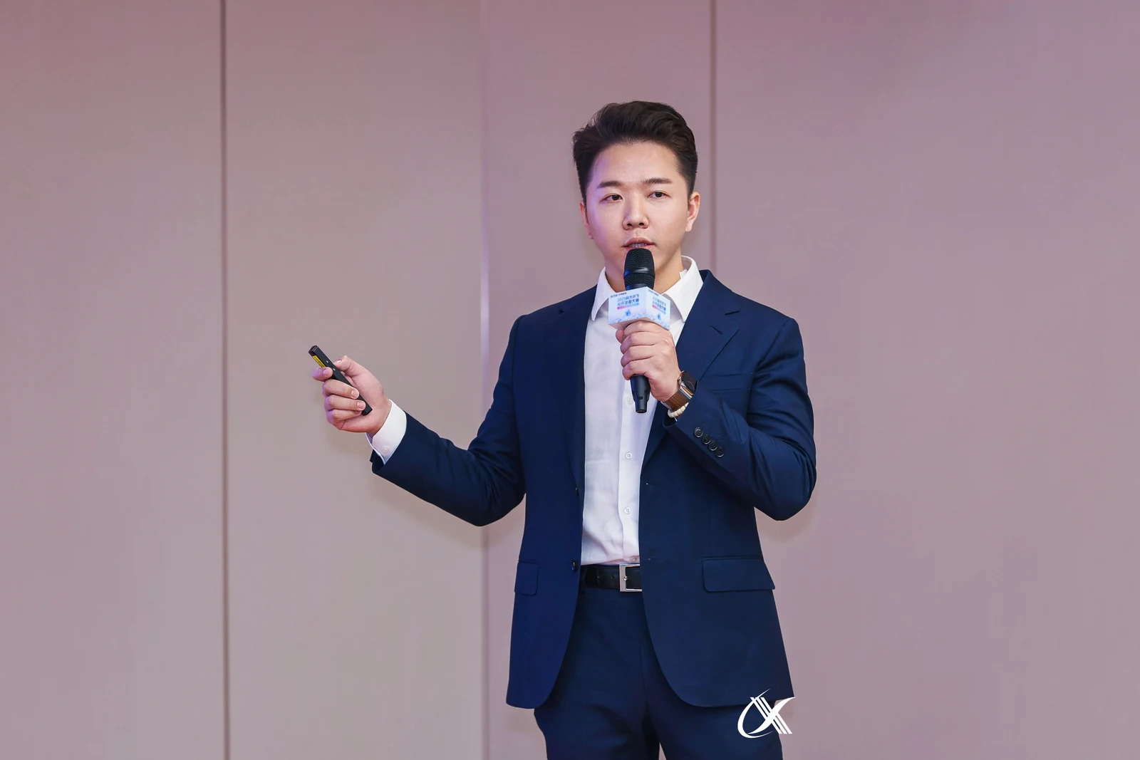 张应善手持麦克风与演示器进行现场分享